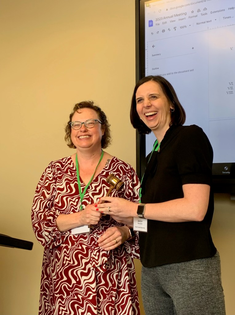 Gretchen handing the gavel to Jacci